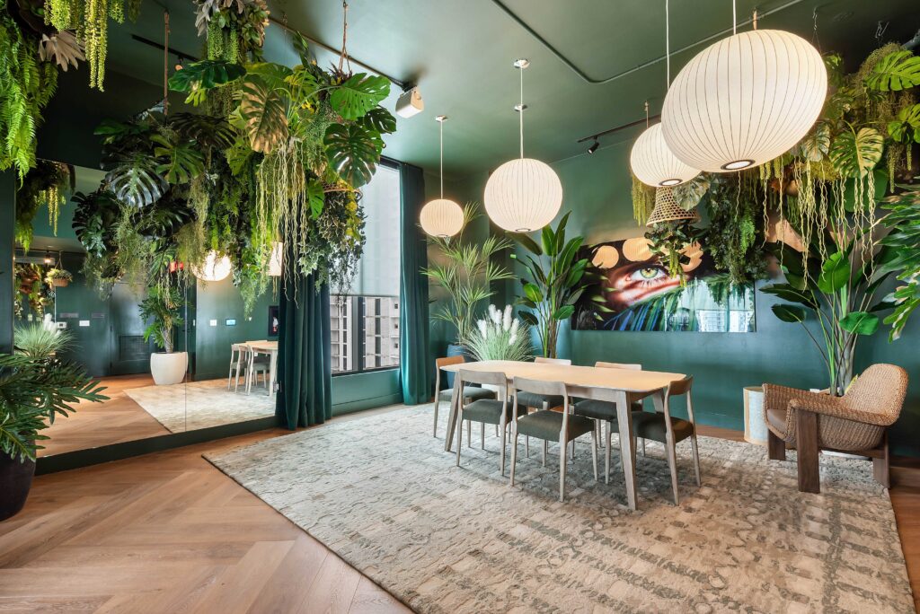 HDR interior photography of a luxury Airbnb dining room with tropical hanging plants and globe pendant lights in Miami — Skyview Real Estate Media
