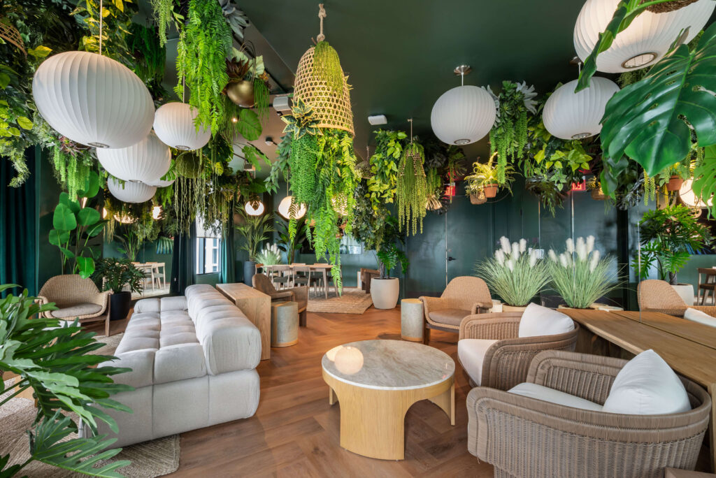 Professional interior photography of a luxury short-term rental lounge with tropical décor and herringbone floors in Miami — Skyview Real Estate Media